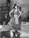 Young woman with a buccaneer hat dancing on a chair