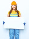 Young woman builder standing against white background with big Royalty Free Stock Photo