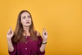 Young woman in burgundy bluse with crossing fingers and wishing the best Royalty Free Stock Photo