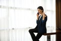 Businesswoman, female employee, young entrepreneur swears, argues, gestures with her hands while talking on the phone, sitting at Royalty Free Stock Photo