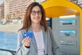 Young woman business worker smiling confident holding credit card at street Royalty Free Stock Photo