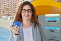 Young woman business worker smiling confident holding credit card at street Royalty Free Stock Photo