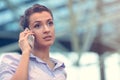 Young woman busy with calling, chatting on the cell phone side view portrait. Royalty Free Stock Photo