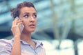 Young woman busy with calling, chatting on the cell phone side view portrait. Royalty Free Stock Photo