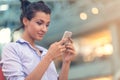 Young woman busy with calling, chatting on the cell phone side view portrait. Royalty Free Stock Photo