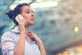 Young woman busy with calling, chatting on the cell phone side view portrait. Royalty Free Stock Photo