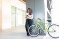 Young Woman Busy Using Smartphone By Bicycle Royalty Free Stock Photo