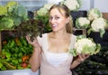 Young woman buying cabbage at market. Royalty Free Stock Photo