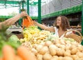 Young Woman Buying Carrots at Grocery Market Royalty Free Stock Photo