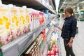 Young woman buying dairy groceries at the supermarket. Selective focus