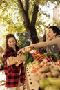 Young woman buying fresh organic vegetables at farmers market Royalty Free Stock Photo