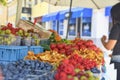 Young woman buying fruit at local farmers market. Fresh organic produce for sale at local farmers market Royalty Free Stock Photo