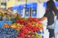 Young woman buying fruit at local farmers market. Fresh organic produce for sale at local farmers market Royalty Free Stock Photo