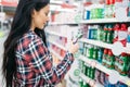 Young woman buying toothbrush in supermarket Royalty Free Stock Photo