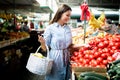 Young woman buying vegetables at the market. Royalty Free Stock Photo