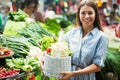 Young woman buying vegetables at the market. Royalty Free Stock Photo