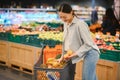Young Woman Buying Vegetables at Grocery Market Royalty Free Stock Photo