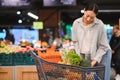 Young Woman Buying Vegetables at Grocery Market Royalty Free Stock Photo
