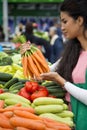 Young woman buying vegetables on the market Royalty Free Stock Photo