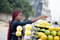 Young woman paying fruits at street market. Royalty Free Stock Photo