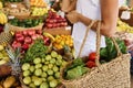 a young woman buys fruits and vegetables at a market. fresh and healthy food. Royalty Free Stock Photo