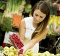 Young woman buys raspberries at market Royalty Free Stock Photo