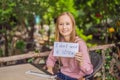 Young woman in a cafe shows a sign - I don`t need a straw. No plastic. Global environmental protection issue Royalty Free Stock Photo