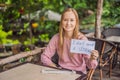 Young woman in a cafe shows a sign - I don`t need a straw. No plastic. Global environmental protection issue Royalty Free Stock Photo