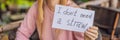 Young woman in a cafe shows a sign - I don't need a straw. No plastic. Global environmental protection issue BANNER Royalty Free Stock Photo