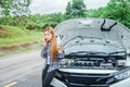 Young Woman calling for assistance with his car broken down by t Royalty Free Stock Photo