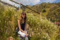 Young woman in camomile field in mountains, Shymbulak, Almaty, K