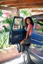 Young woman in a camper van in a beautiful camping with pink flowers