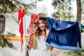 Young woman on camping holiday, hanging clothes on washing line. Royalty Free Stock Photo