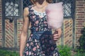 Young woman with candyfloss outside