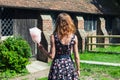 Young woman with candyfloss outside