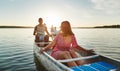 Young woman canoeing with friends on a summer afternoon Royalty Free Stock Photo