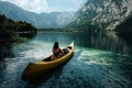 Young woman canoeing in the lake bohinj on a summer day Royalty Free Stock Photo