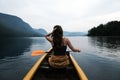 Young woman canoeing in the lake bohinj on a summer day Royalty Free Stock Photo