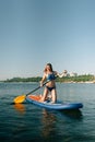 Young woman canoeing in a lake. Woman paddling kayak on a summer day. Royalty Free Stock Photo