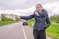 Young woman with a car breakdown wants to hitchhike