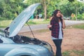 Young woman with car breaks down and she is calling the emergency services. Royalty Free Stock Photo