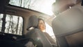 Young woman in a car,female driver looking at the passenger and smiling.Enjoying the ride,traveling,road trip concept.Driver