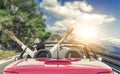 Young woman in a car on the road to the sea against a backdrop of beautiful mountains on a sunny day. Royalty Free Stock Photo