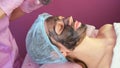 Young woman with carbon nanogel on her face in salon