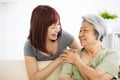 Young woman carefully takes care of old woman