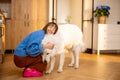 Woman with Maremma dog at home