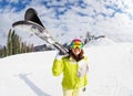 Young woman carry mountain ski on winter resort