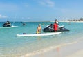 Young woman carrying board at Kate beach in Dubai. Family making vacations and enjoying summer. Royalty Free Stock Photo