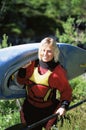 Young woman carrying kayak