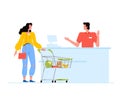 Young woman with a cart of groceries stands at the checkout in a supermarket. The cashier communicates with the customer Royalty Free Stock Photo